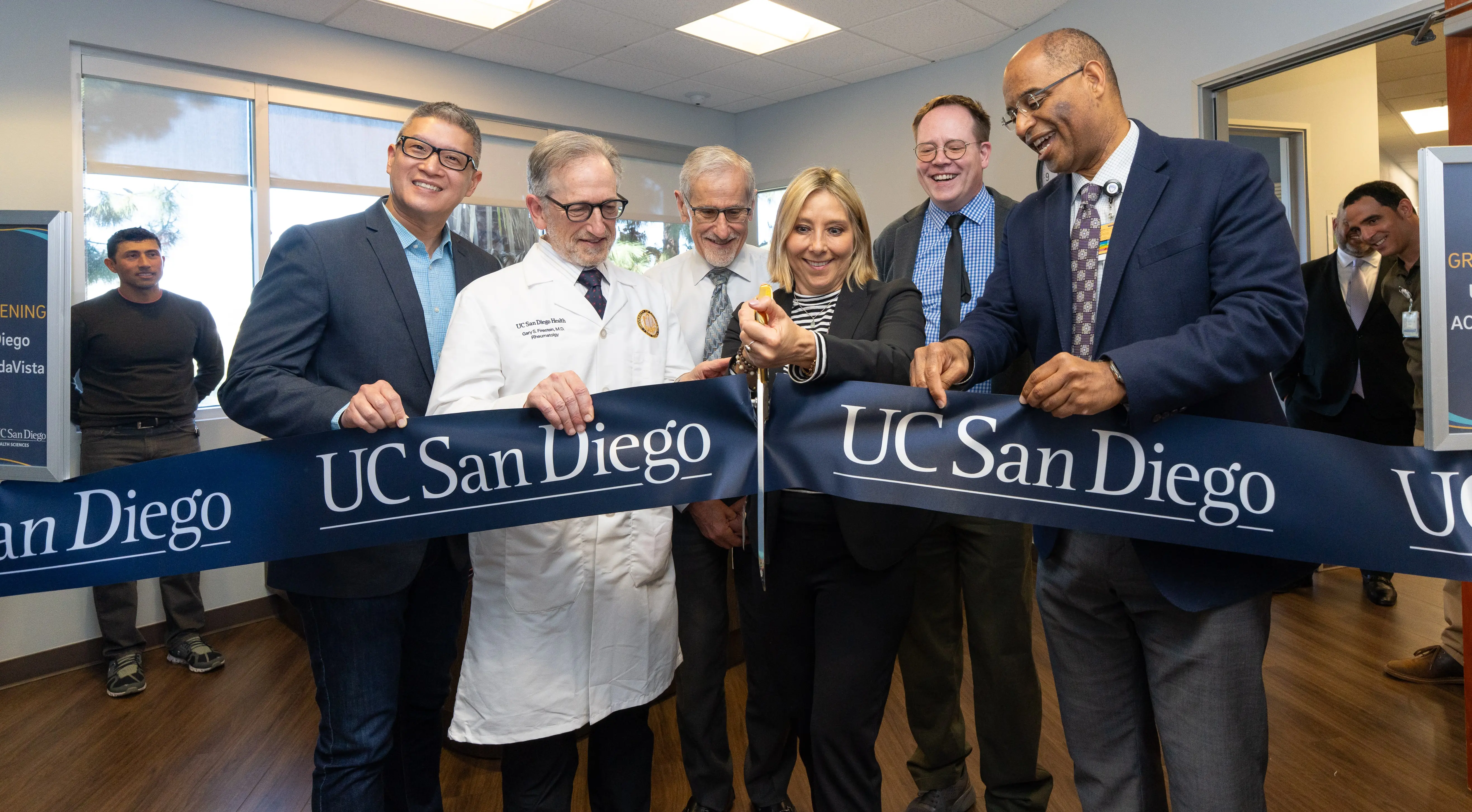 UC San Diego and UC San Diego Health Sciences leaders cutting a ribbon for a clinic opening