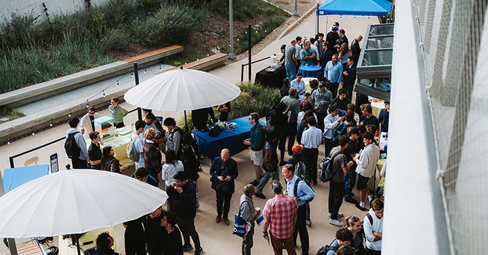 Outside The Basement, attendees explore all of the student innovations on display.